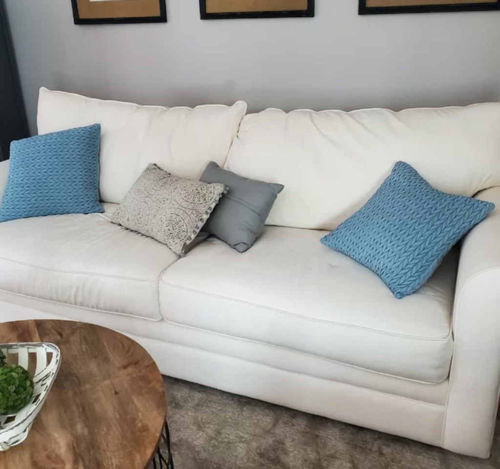close up of white sofa with blue pillows