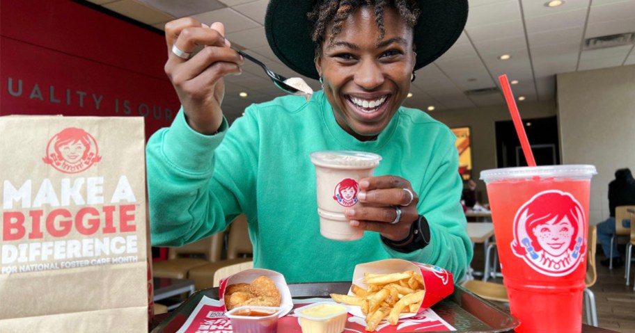 woman eating a wendys frosty
