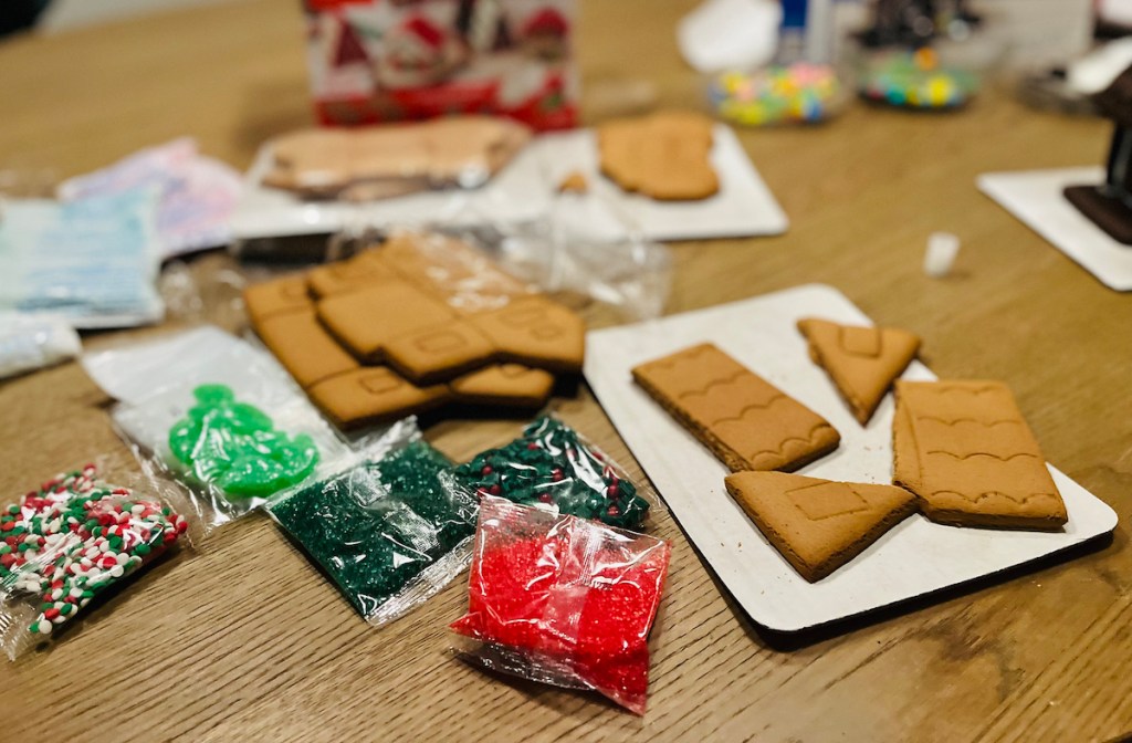 gingerbread pieces and candies for decorating on table