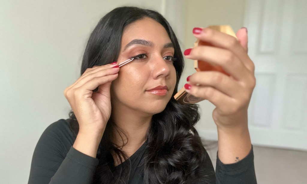 woman applying lashes 