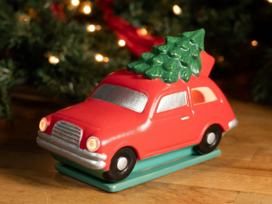 a wax warmer shaped like a red car with a Christmas tree on top