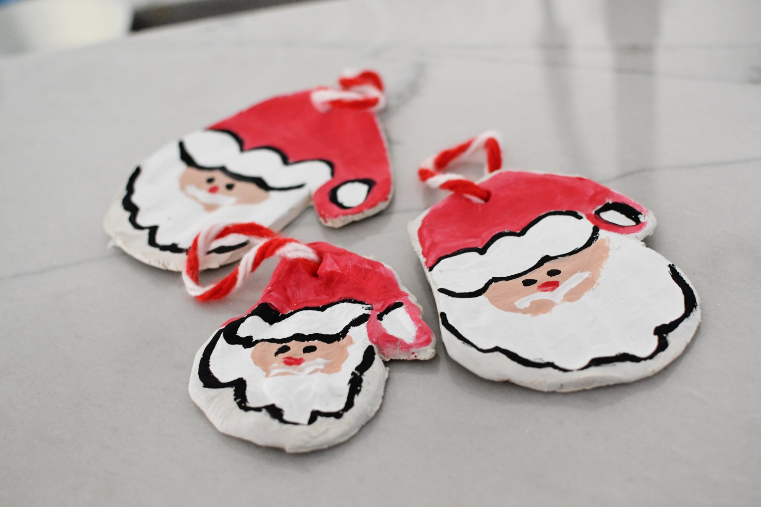 The Easiest DIY Santa Ornaments Using Handprints & Air-Dry Clay
