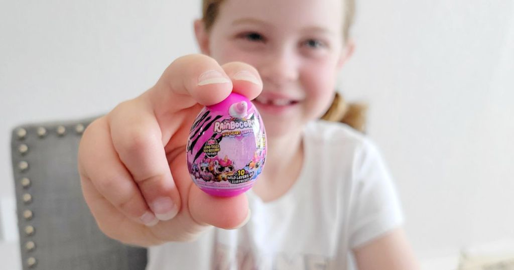 Girl holding a mini brands toy up