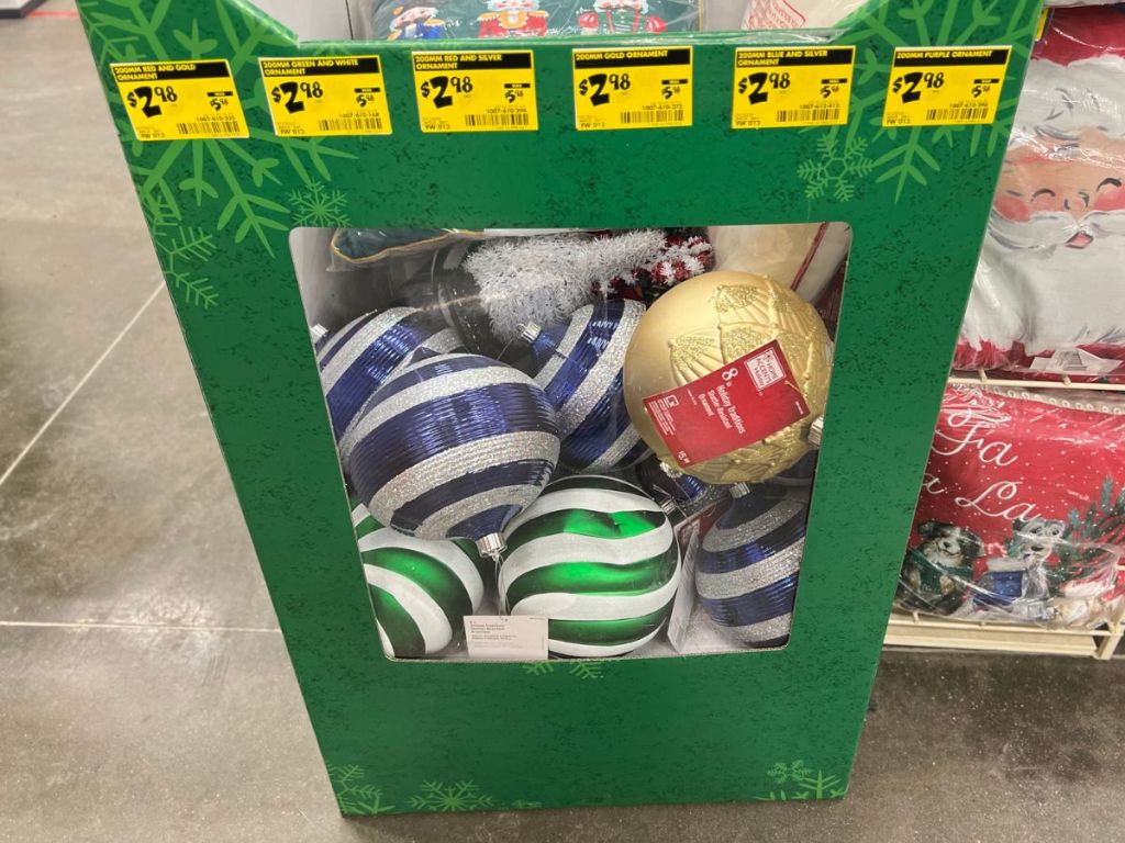 store display at home depot of 8 inch holiday ornaments