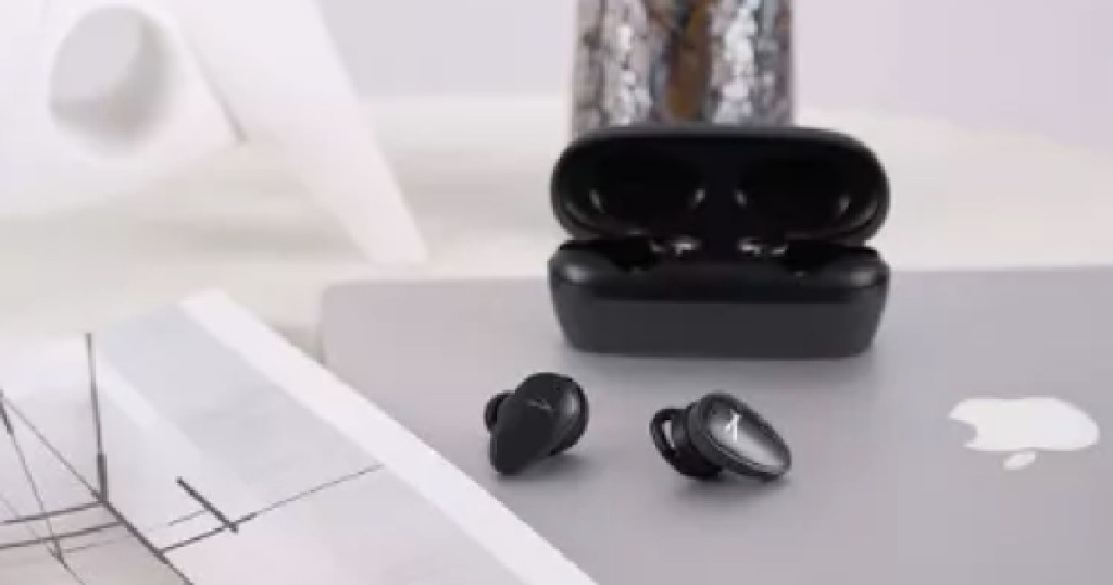 black ear buds on silver computer