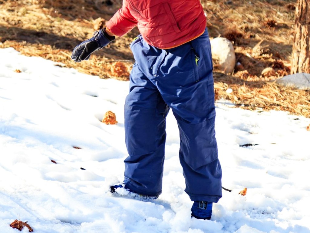 boy wearing blue snow pants