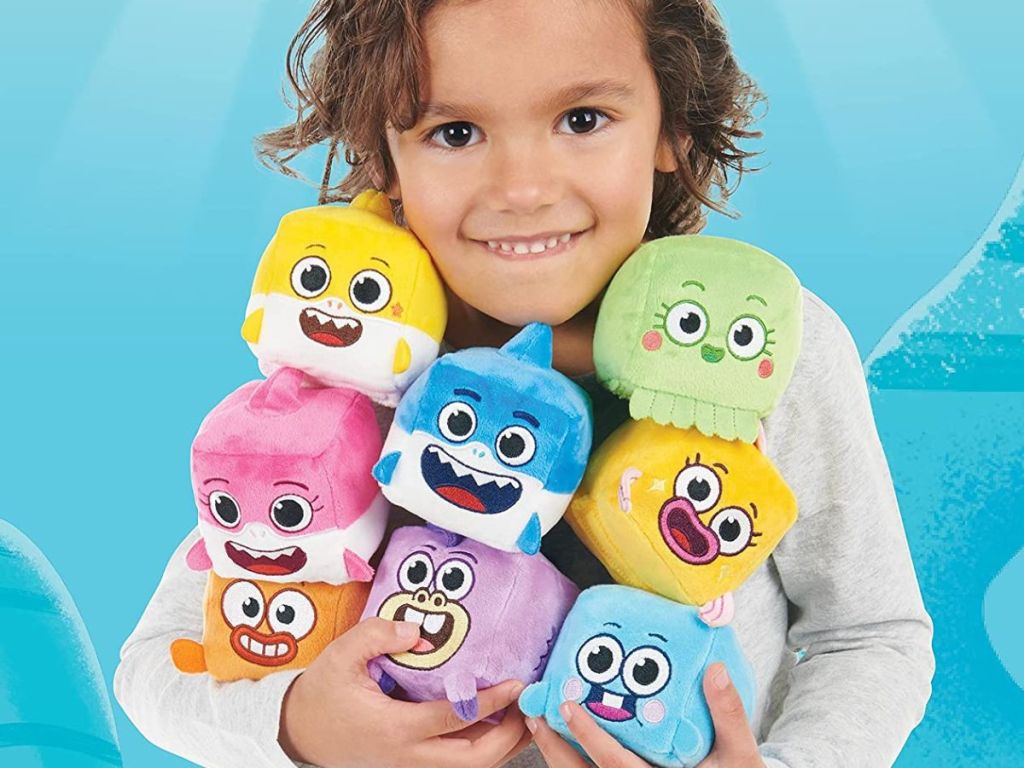 girl holding Baby Shark Singing Cubes