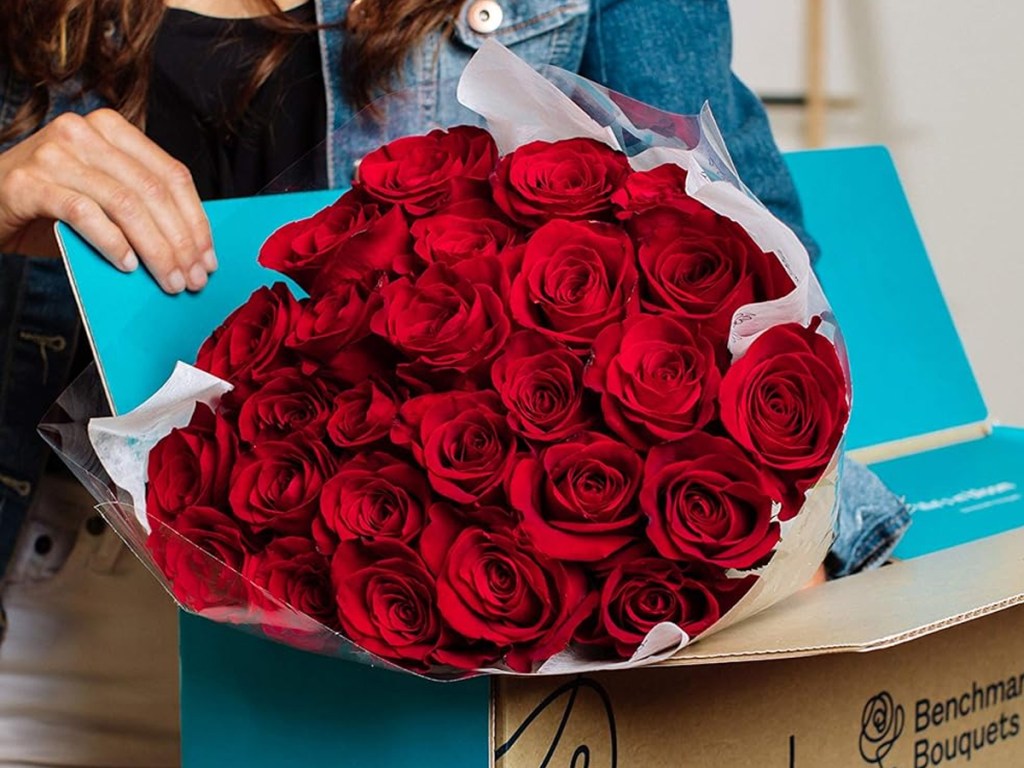 taking bouquet of red roses out of shipping box