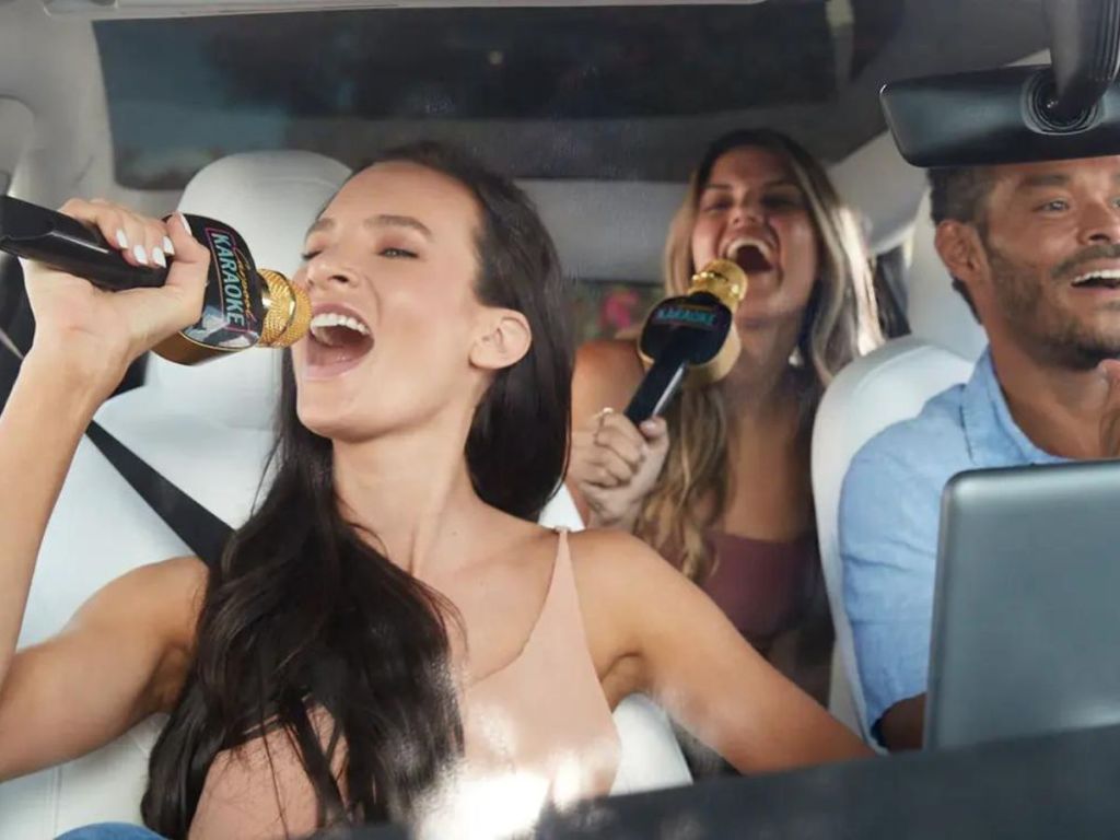 women and man using Carpool Karaoke The Mic in car