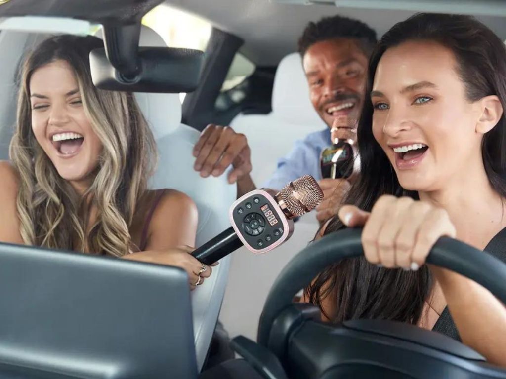 women and man using Carpool Karaoke The Mic in car