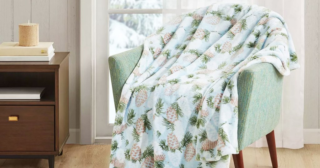 winter pinecone print blanket on a chair