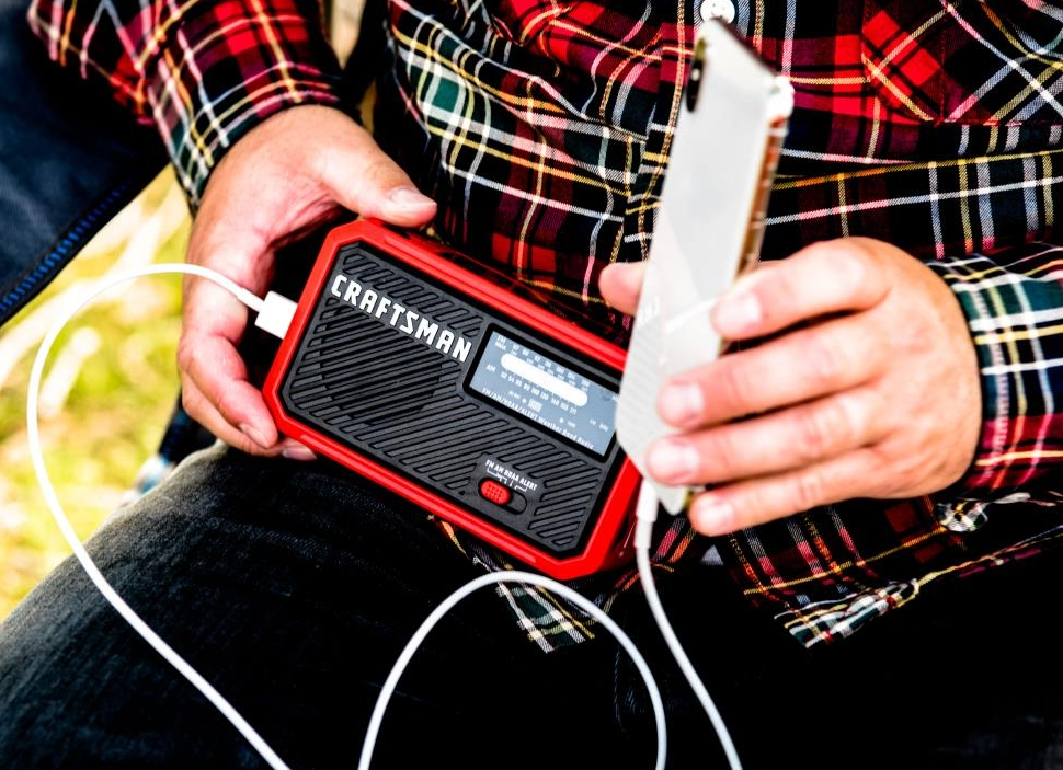 person holding a Craftsman Weather Radio