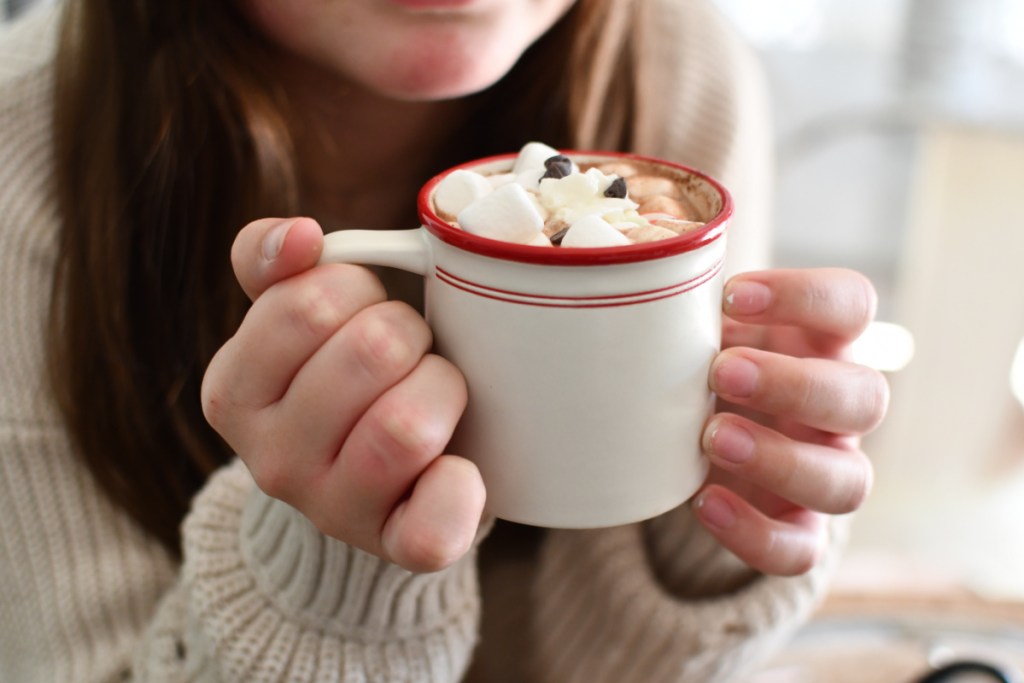 Girl holding a mug of Crockpot hot chocolate
