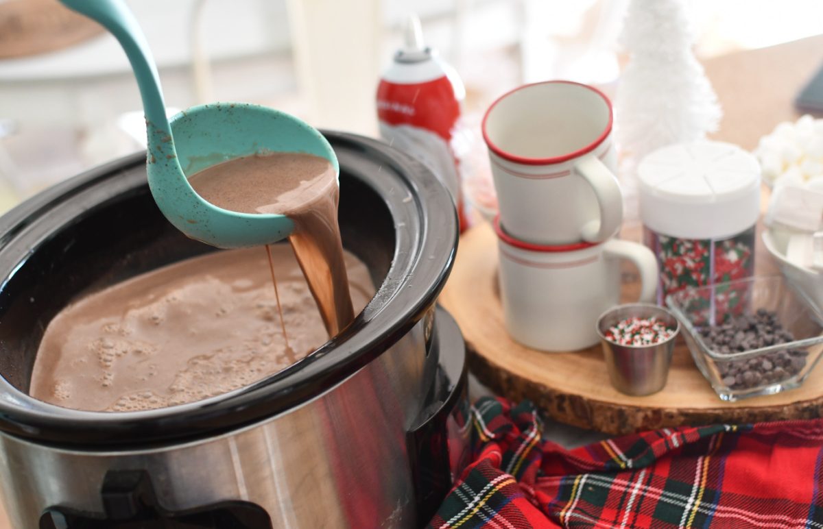 A ladle holding slow cooker hot chocolate