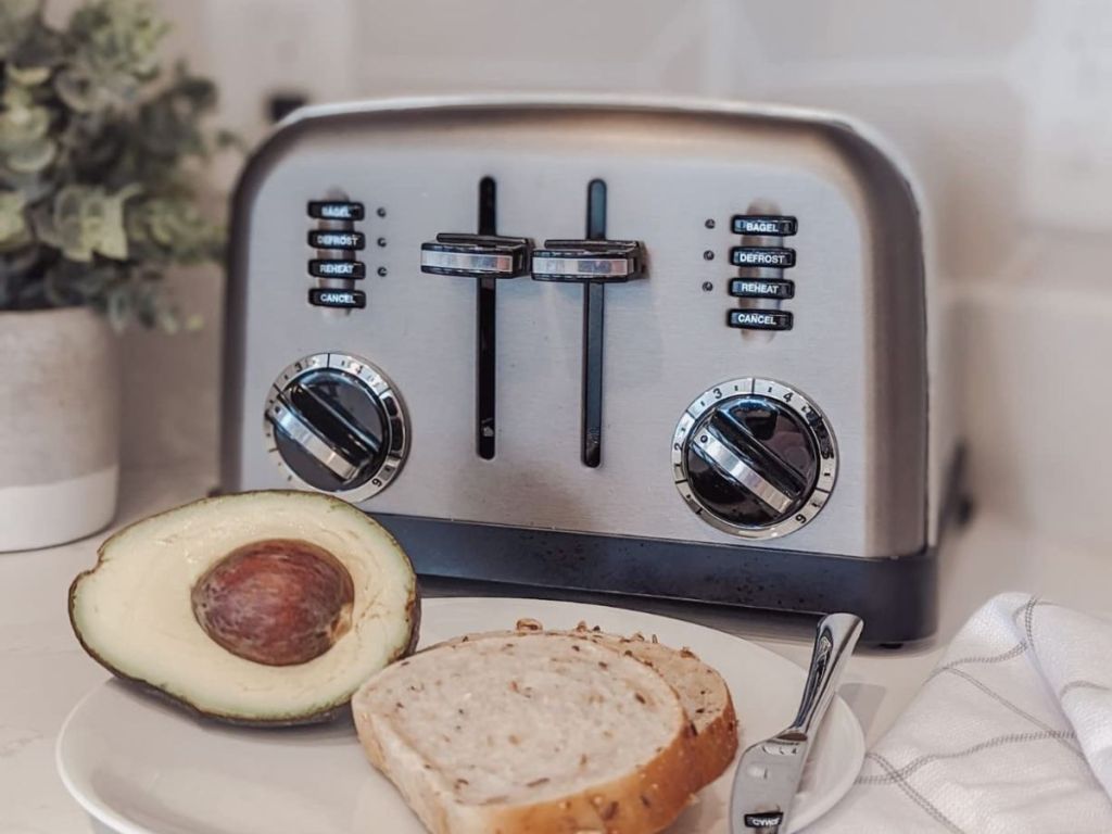 A toaster with avocado and bread