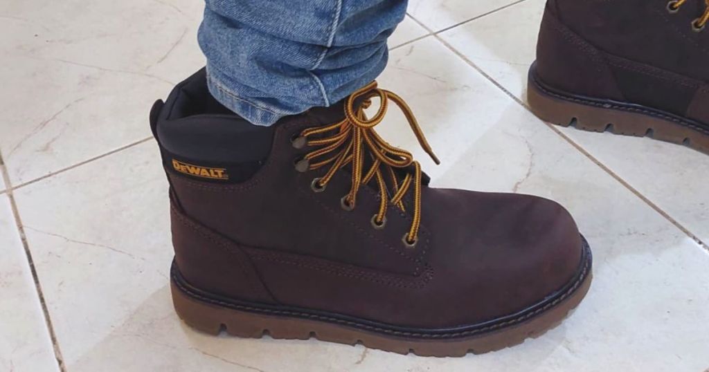 DeWalt work boot on a persons foot.