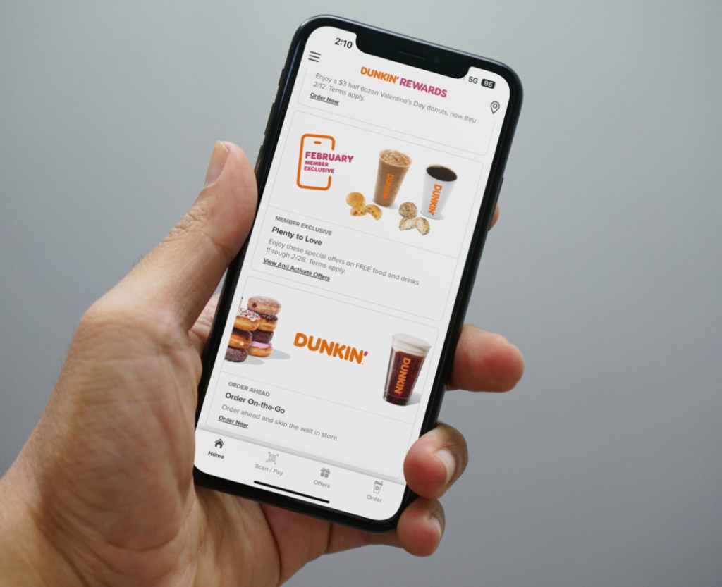 Man showing the Dunkin' Donuts Coupons in the Dunkin' Rewards App on his phone