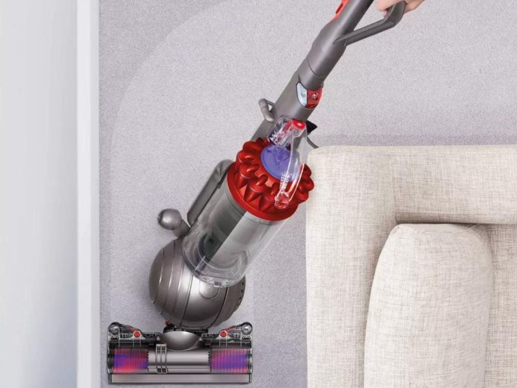 person using vacuum to clean carpets