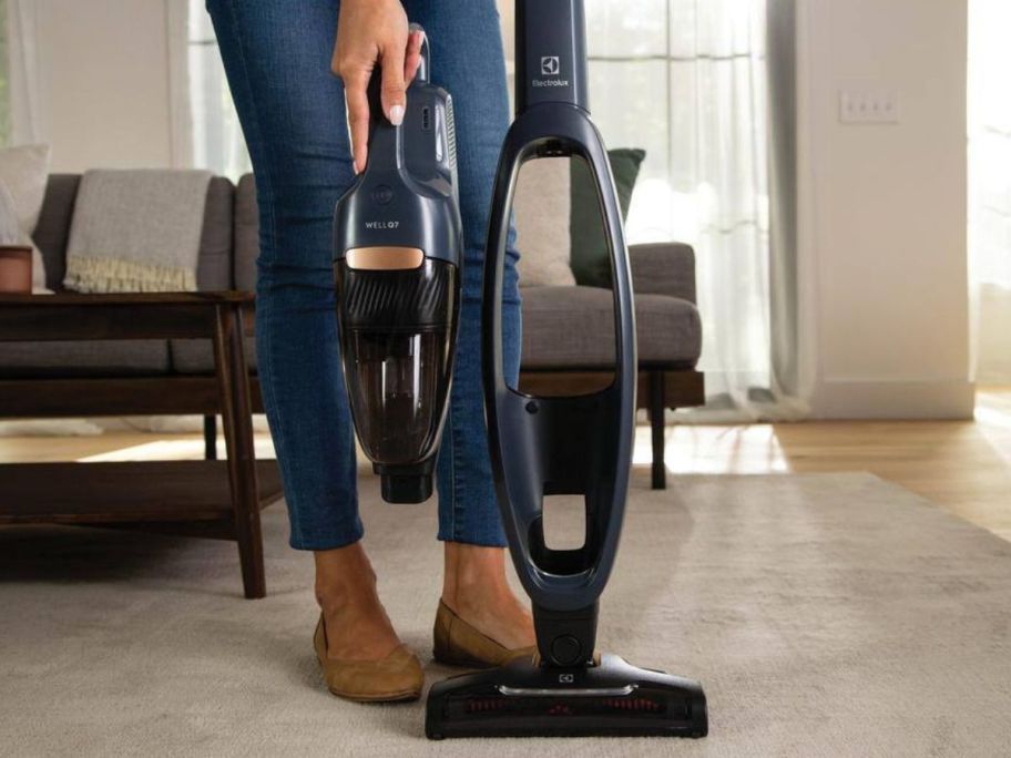 Woman with the handset separated from the Electrolux Well Q7 Bagless Cordless Multi-Surface Stick Vacuum w/ 5-Step Filtration 