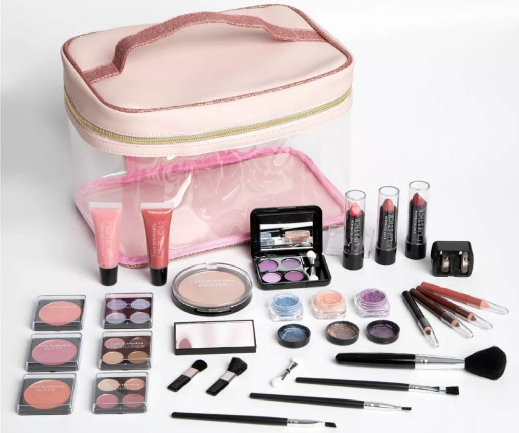 contents of makeup kit next to pink bag