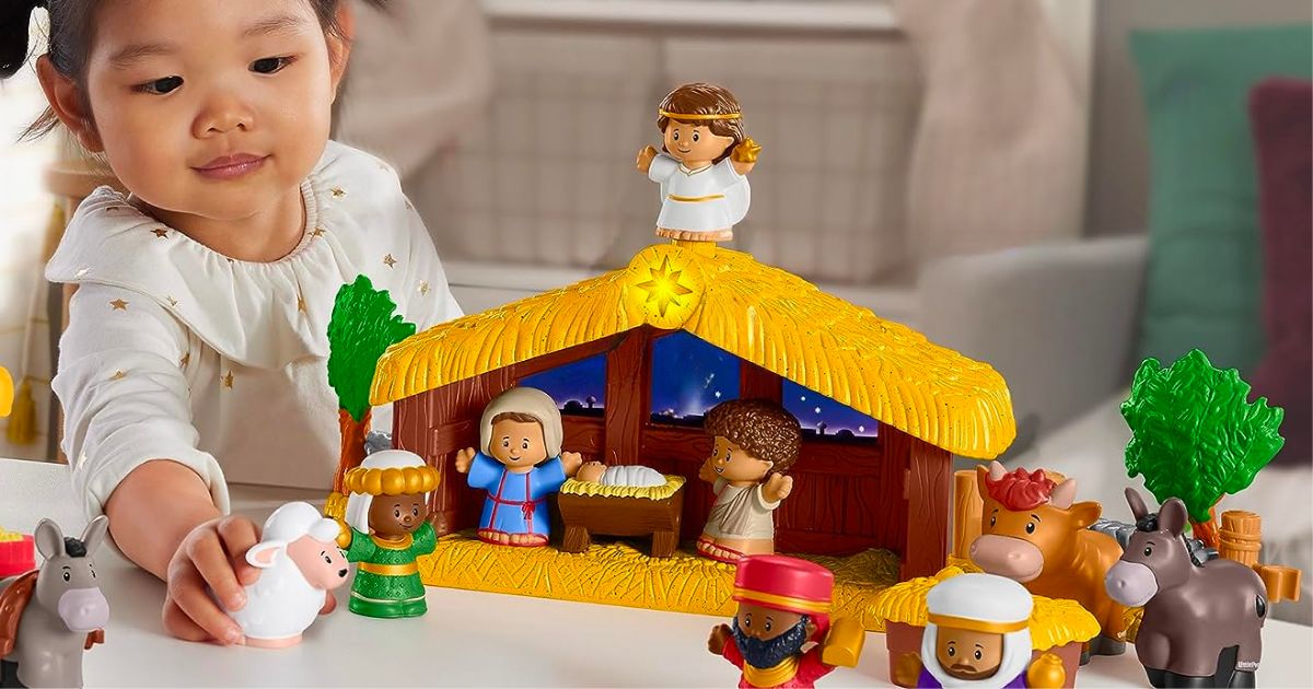 a little girl playing with a Fisher-Price Little People Toddler Toy Nativity SeT4