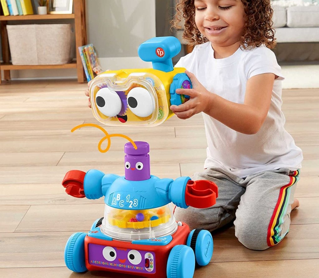 girl playing with a Fisher-Price Robot Toy