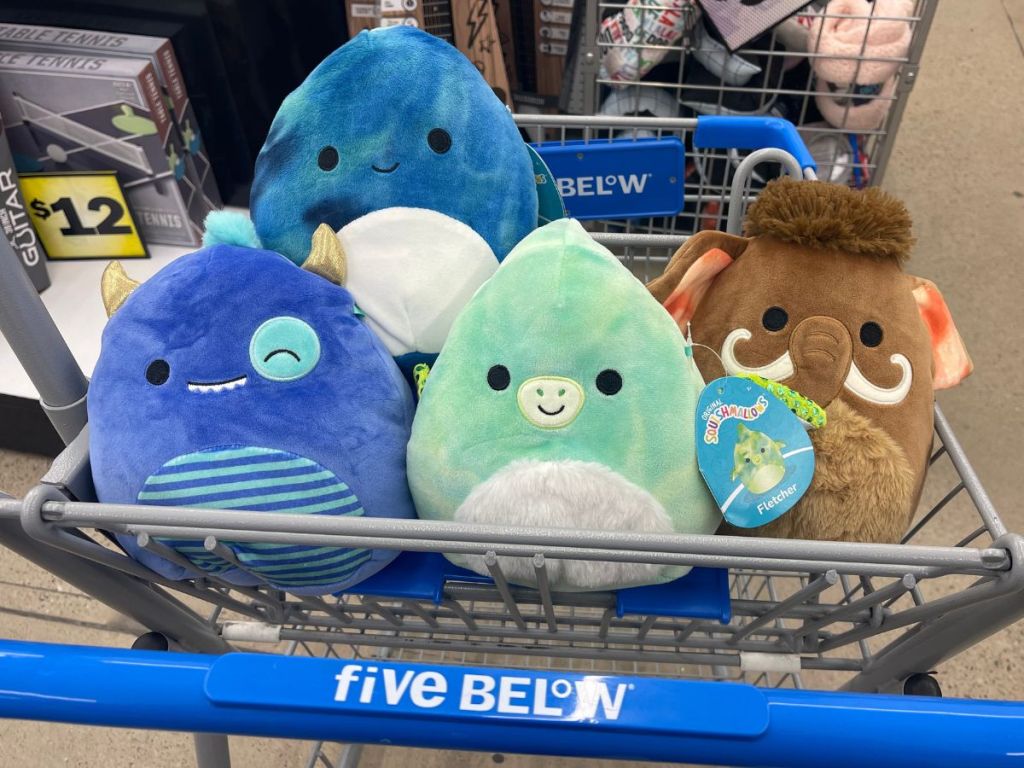Squishmallows sitting in top of five below cart
