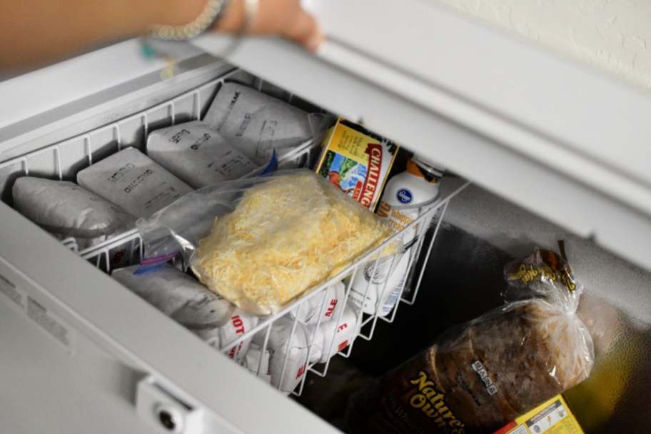 A freezer full of food items like bread and dairy products, which is one way how to save on groceries in 2024