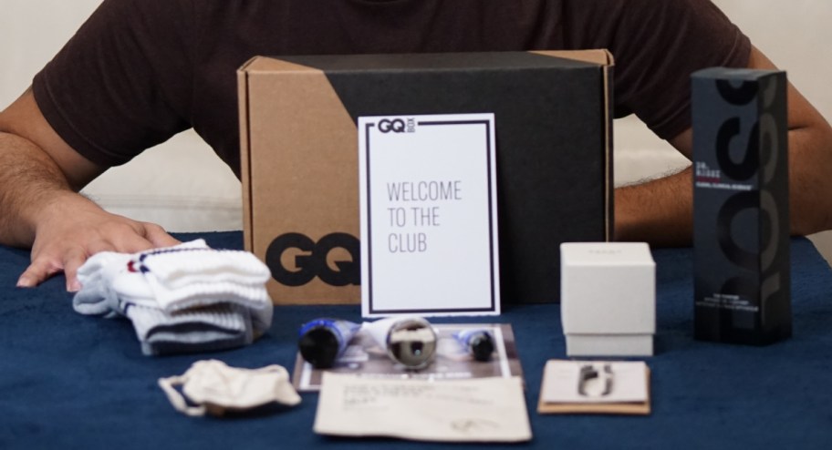 mens items organized in front of box