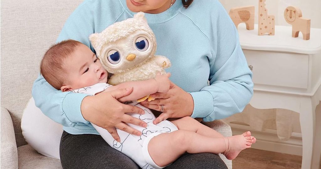 baby holding a stuffed animal owl