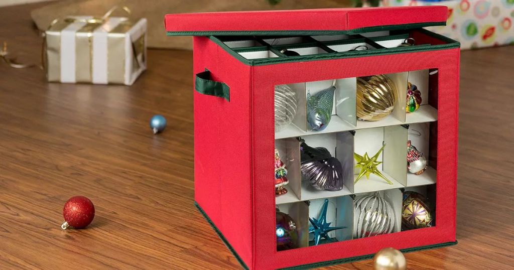 Honey-Can-Do Small Ornament Storage Cube with ornaments in it sitting by a Christmas tree