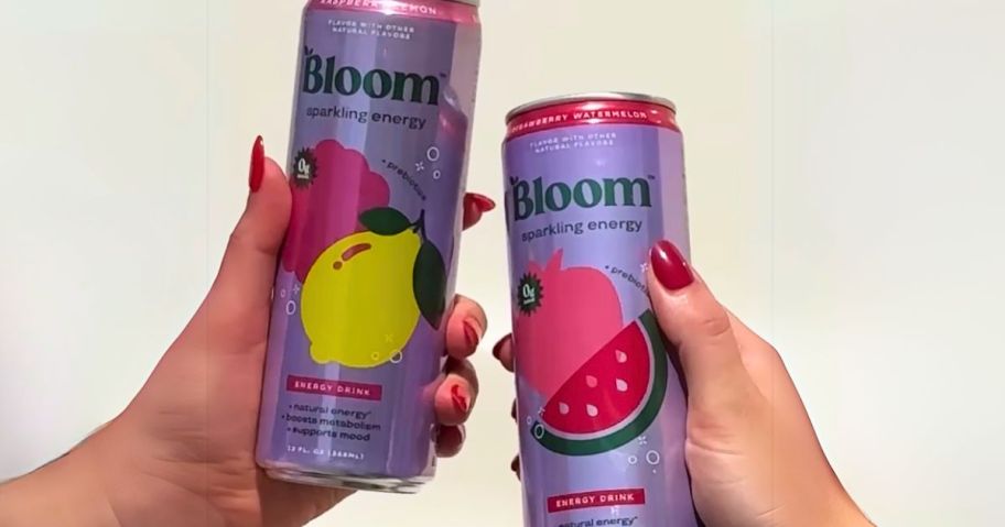 2 hands each holding up a bloom nutrition sparkling energy drink can