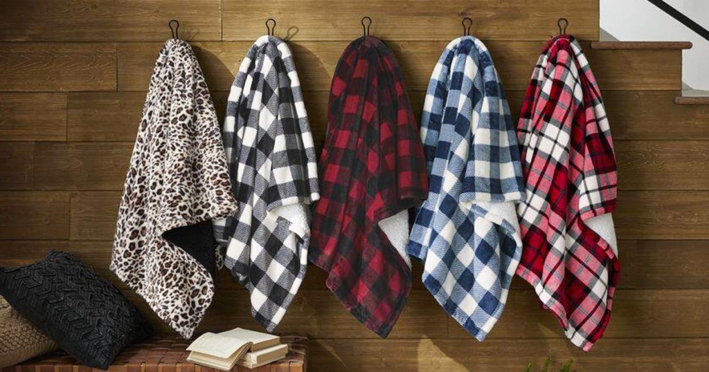throw blankets hanging on hooks on wall