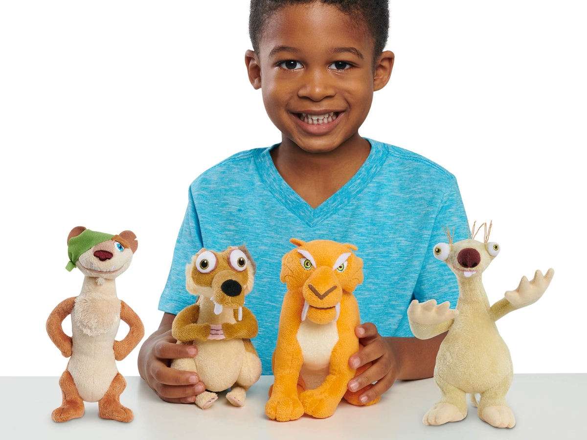 boy playing with four plush ice age toys