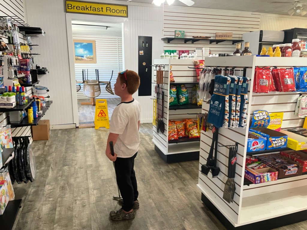 A young boy browsing the aisle of the general store at the KOA Holiday North Jacksonville location