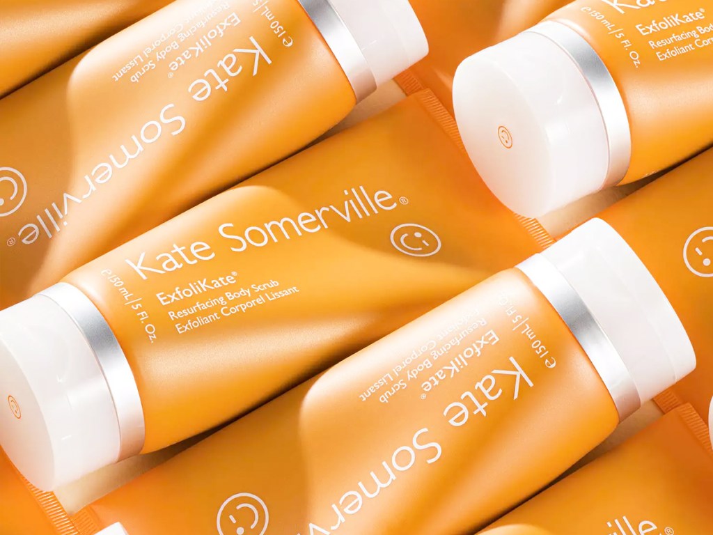 multiple orange tubes of Kate Somerville ExfoliKate Resurfacing Body Scrub