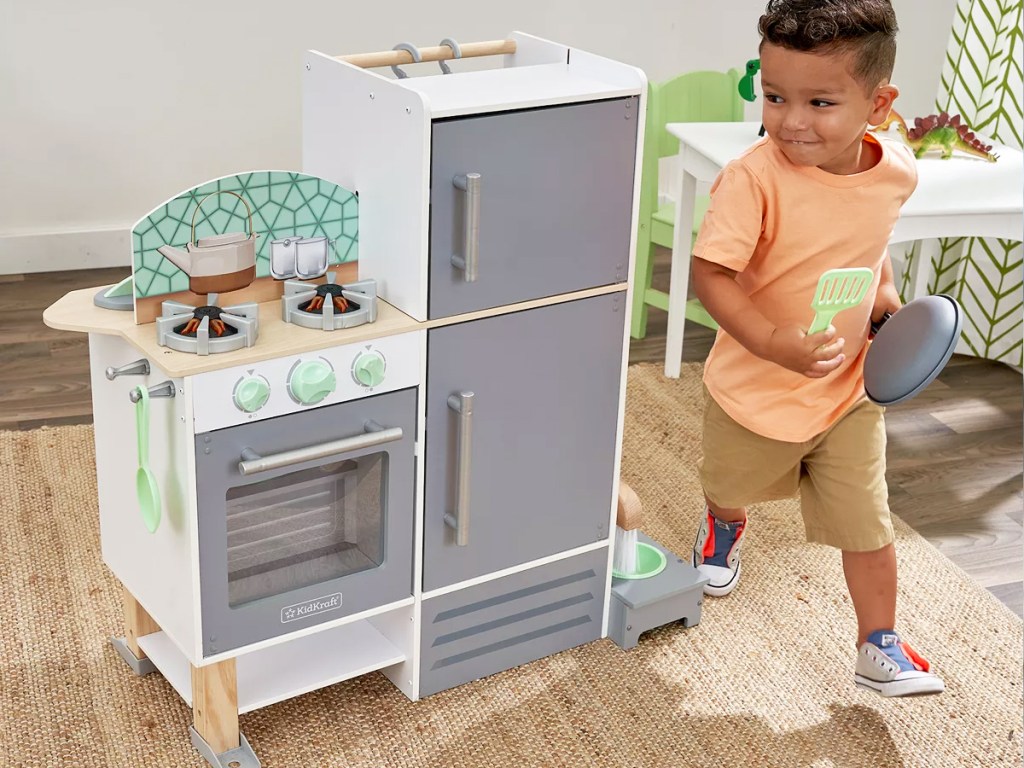 boy playing with kitchen playset