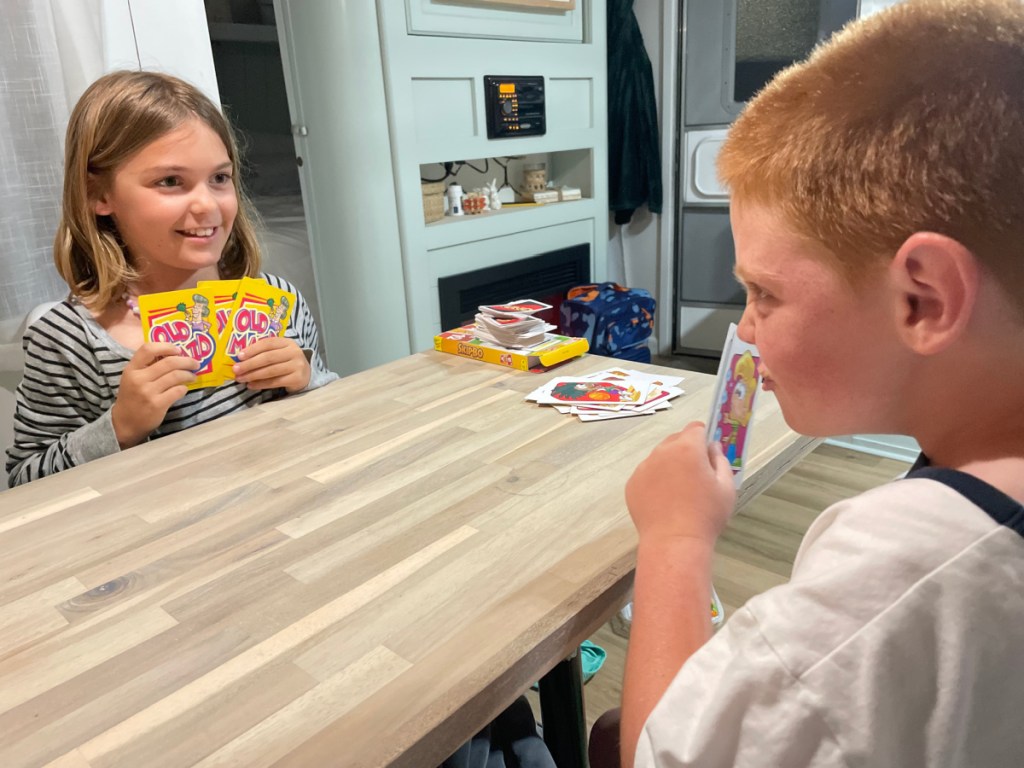 Kids playing cards in an RV rental by RVshare