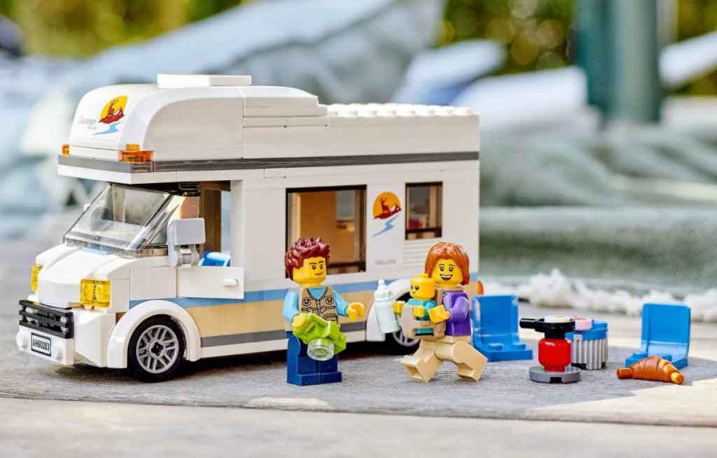 The LEGO City Holiday Camper Van Building Kit displayed on outdoor table