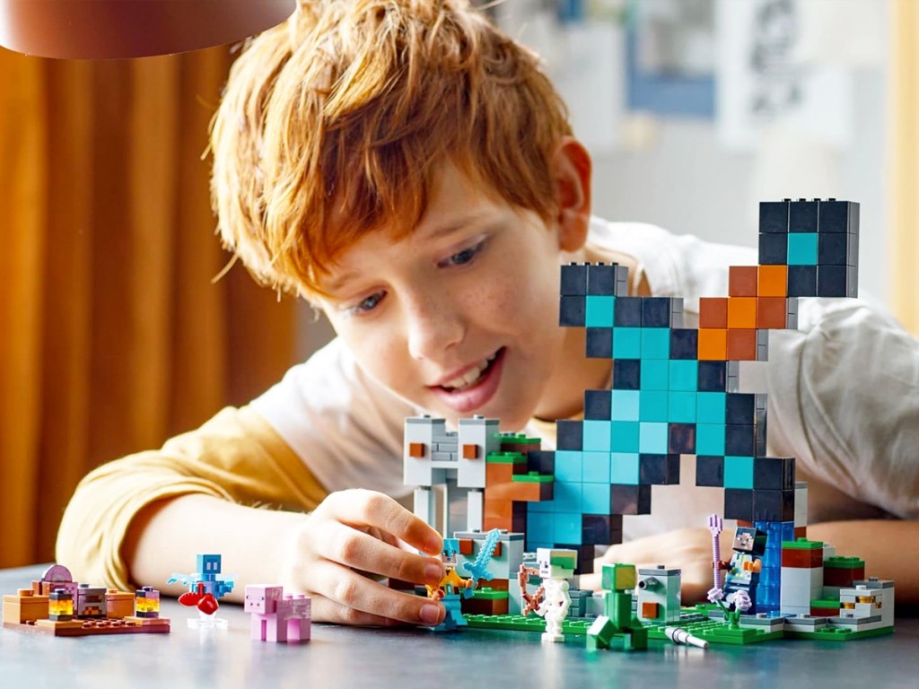 boy playing with lego minecraft set