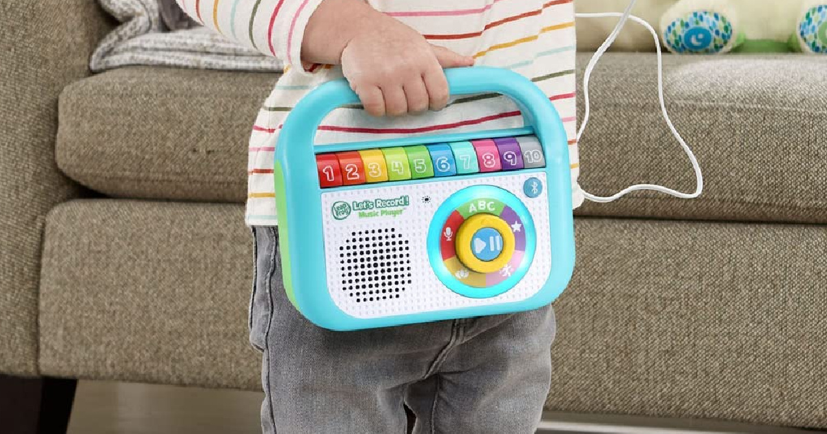 girl holding a LeapFrog Lets Record! Music Player