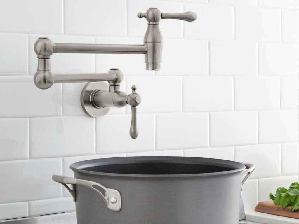 a pot filler in a kitchen with a pot beneath it 
