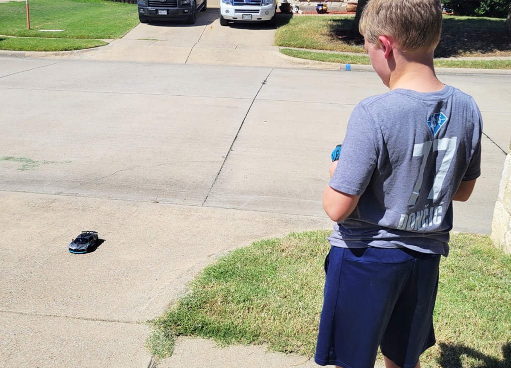 boy playing with Bugatti RC car