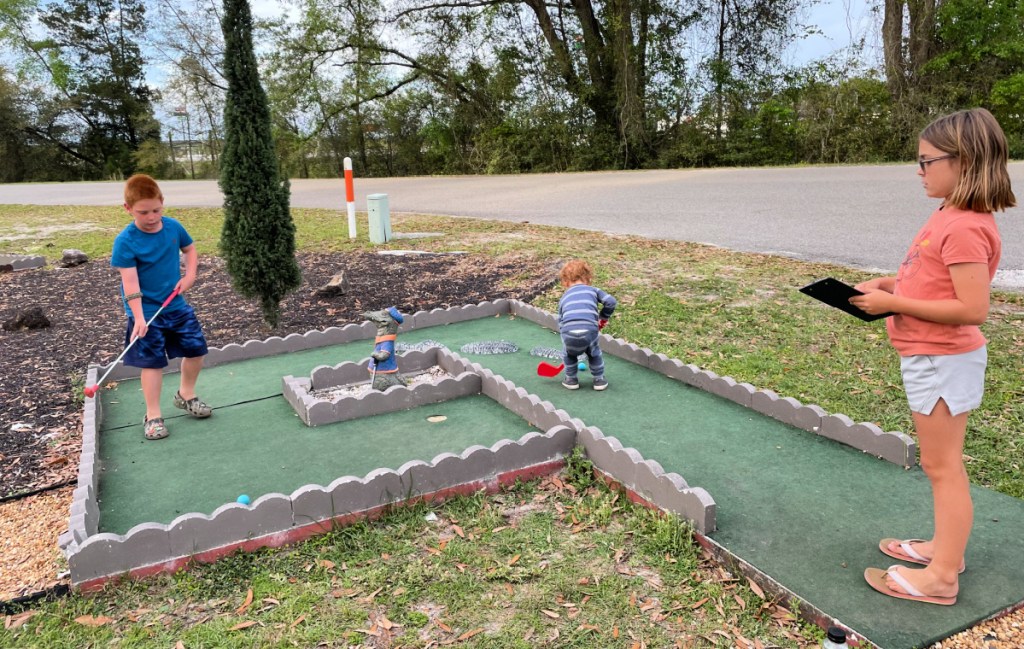 Kids playing mini golf at a KOA