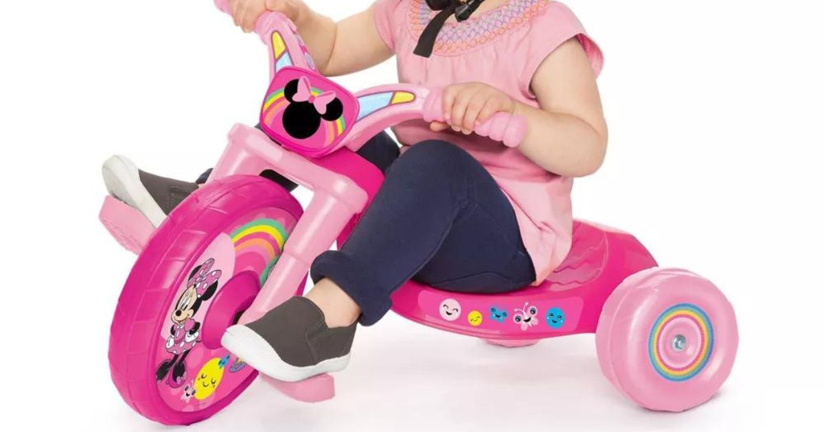 A little girl riding on Minnie mouse fly wheels