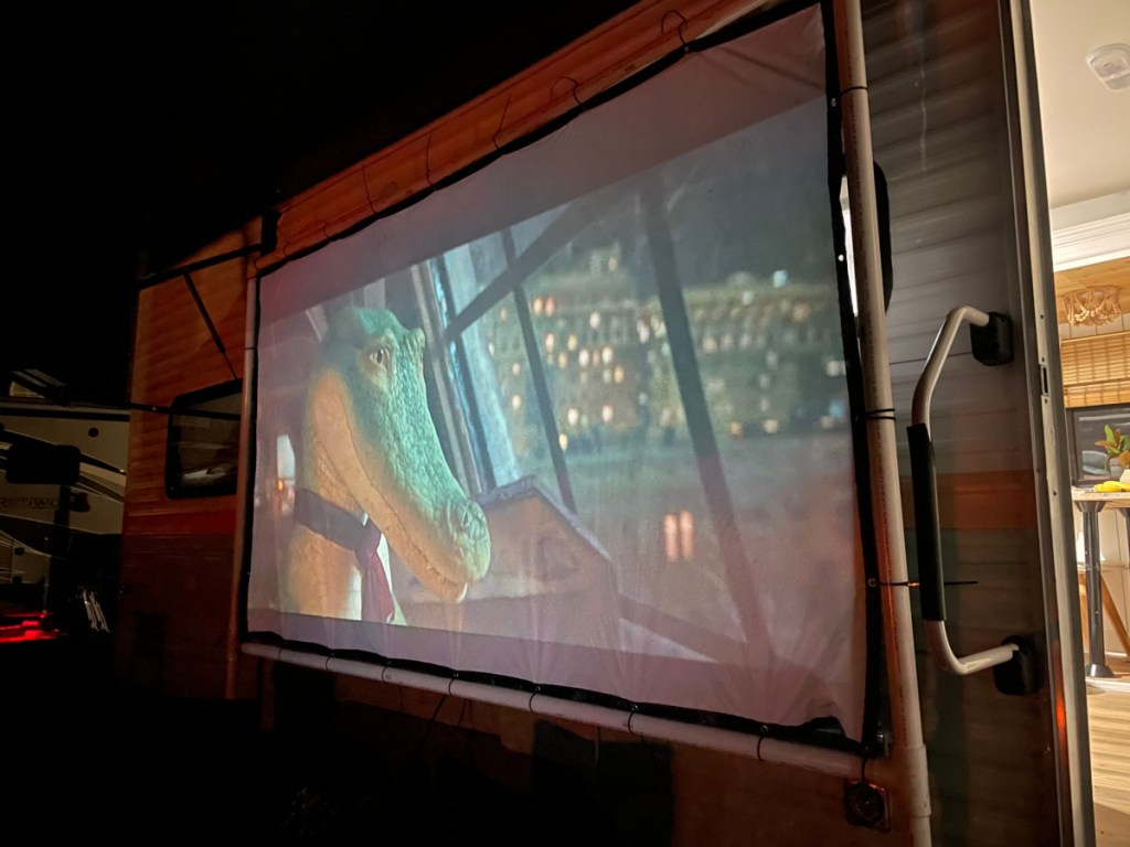Lyle Lyle Crocodile playing on an outdoor movie projector that came with an RV rental from RVShare