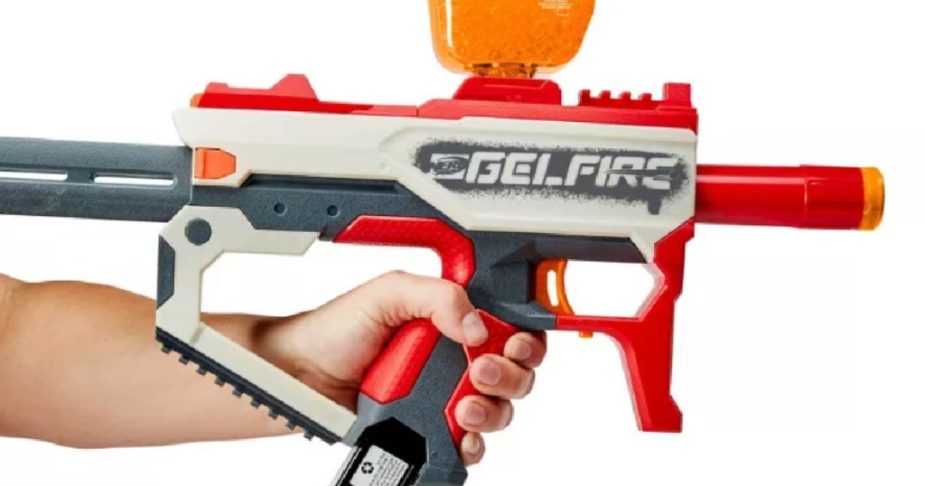 hand holding red and grey toy gun