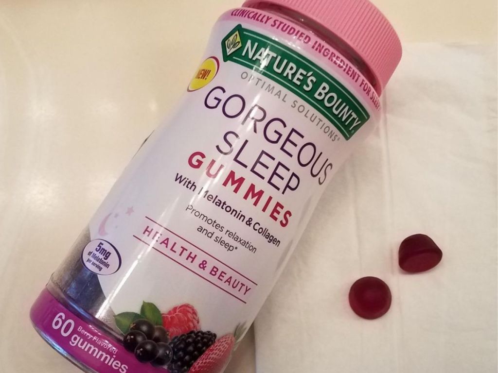 Bottle of Nature's Bounty Gorgeous Sleep Gummies with two gummies next to it