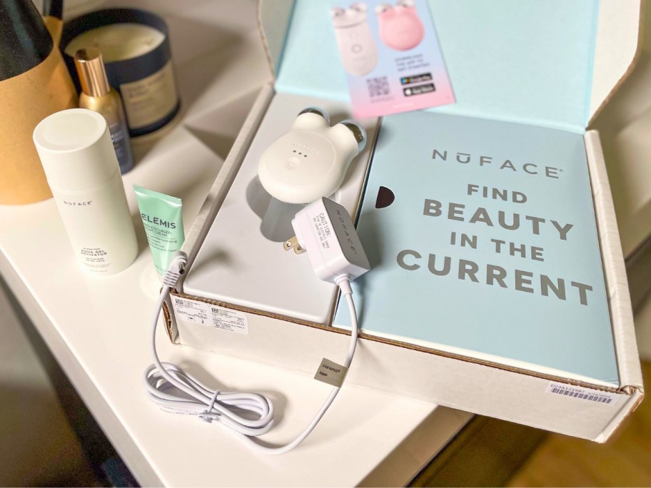 box with NuFace Mini+, Aqua Gel & Elemis Pro Collagen Night Cream on a bathroom counter