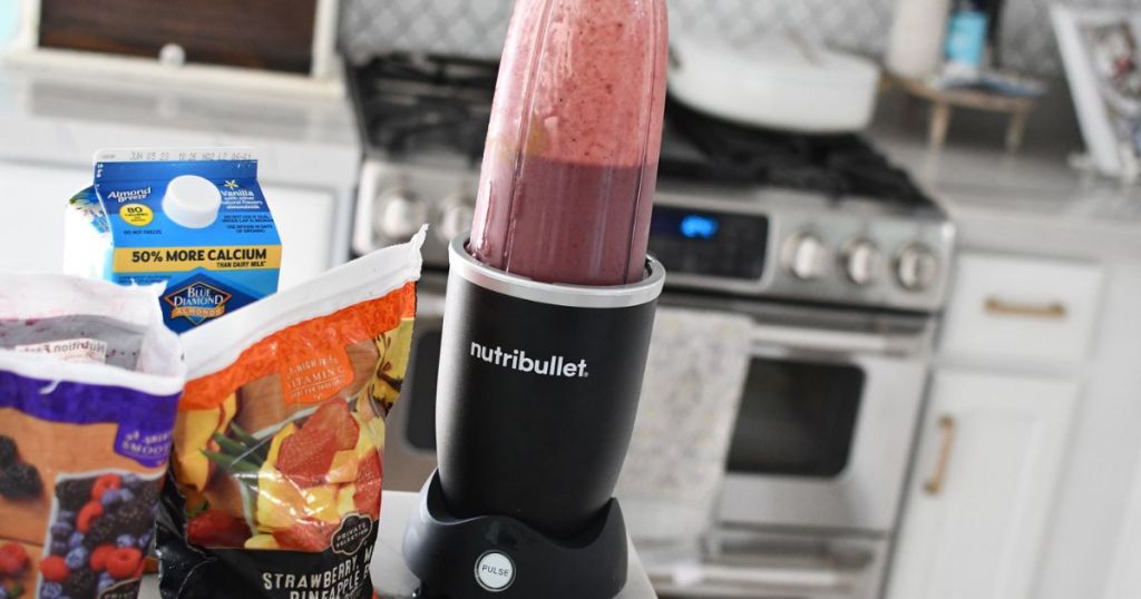 Nutribullet Pro+ Blender on a counter mixing a berry amoothie 